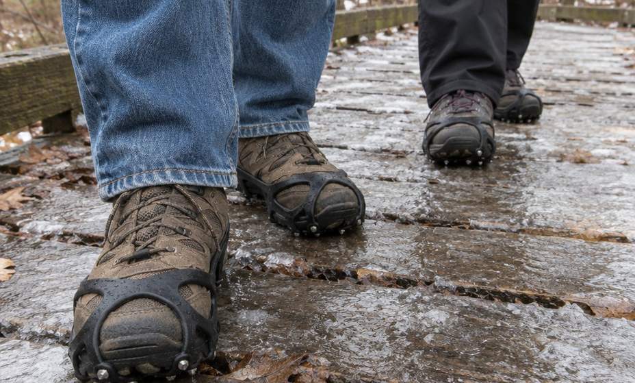 Rubber traction cleats stretched over an ordinary walking shoe on icy boardwalk planks